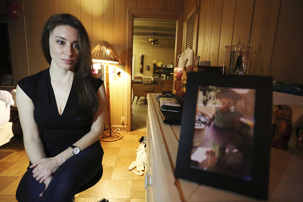 In this Feb. 13, 2017 photo, Casey Anthony poses for a portrait next to a photo of her daughter, Caylee, in her West Palm Beach, Fla., bedroom. In an exclusive interview with The Associated Press, Anthony claims the last time she saw Caylee she “believed that she was alive and that she was going to be OK.” (AP Photo/Joshua Replogle)