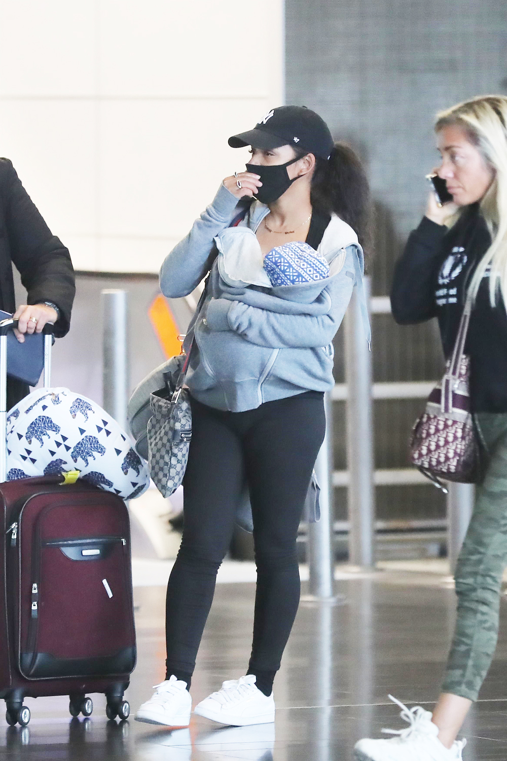 *EXCLUSIVE* Christina Milian wears a protective mask while arriving at Paris-Charles De Gaulle airport with her son Isaiah!