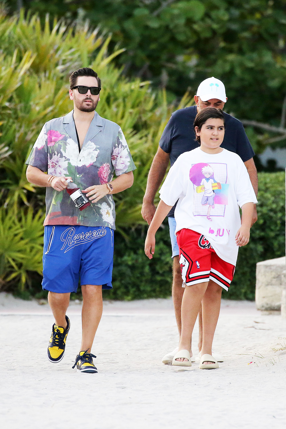 EXCLUSIVE: Scott Disick looks relaxed as he hits the beach with son Mason in Miami following Kourtney Kardashian's engagement announcement