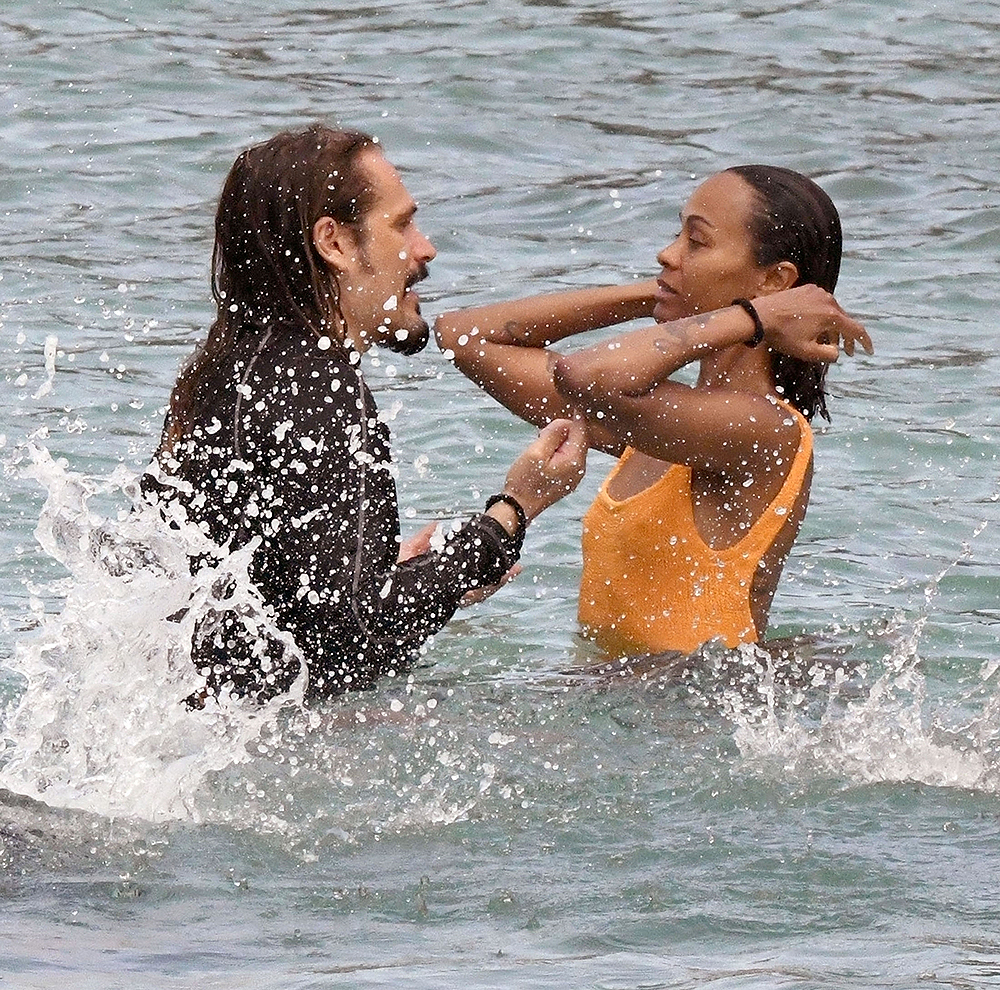 *EXCLUSIVE* Showing off her sexy little figure wearing her striking orange swimsuit, Zoe Saldana and husband Marco Perego enjoy a swim at Pevero beach during their family holiday in Sardinia