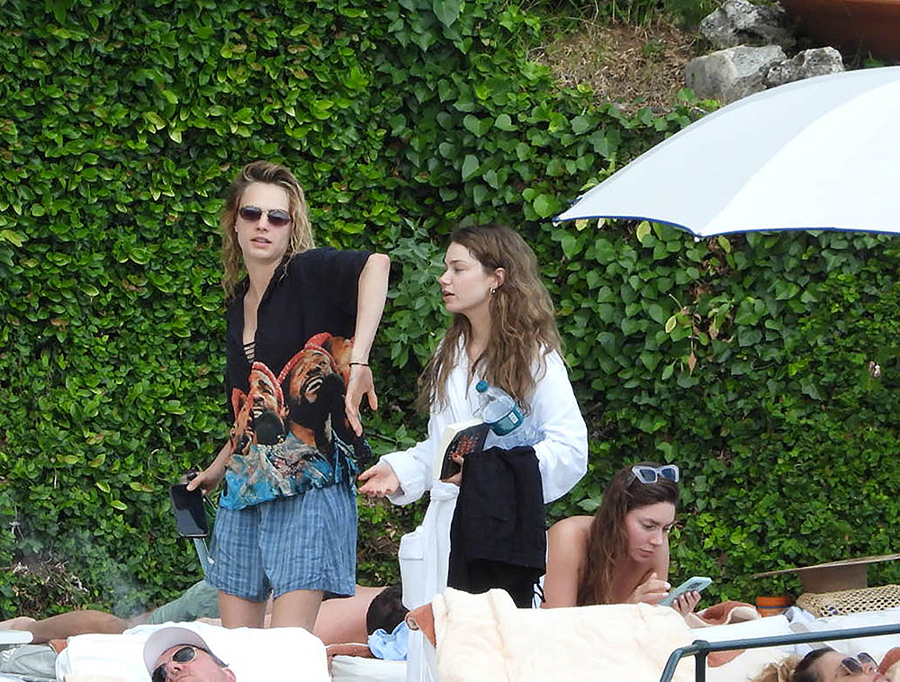 Cara Delevingne, wearing a t-shirt with Bob Marley's picture, seen kissing a new girlfriend singer Minke in the park of Hotel Splendido in Portofino