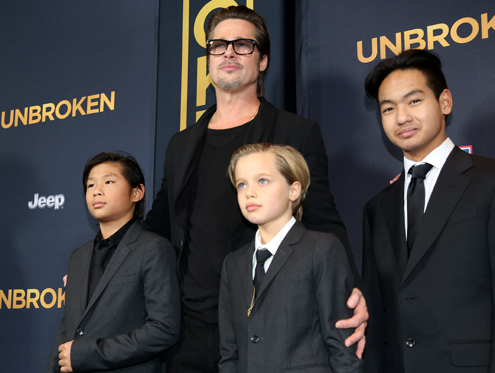 Pax Jolie-Pitt, from left, Brad Pitt, Shiloh Jolie-Pitt and Maddox Jolie-Pitt arrive at the Los Angeles premiere of "Unbroken" at TCL Chinese Theatre on Monday, Dec. 15, 2014. (Photo by Matt Sayles/Invision/AP)