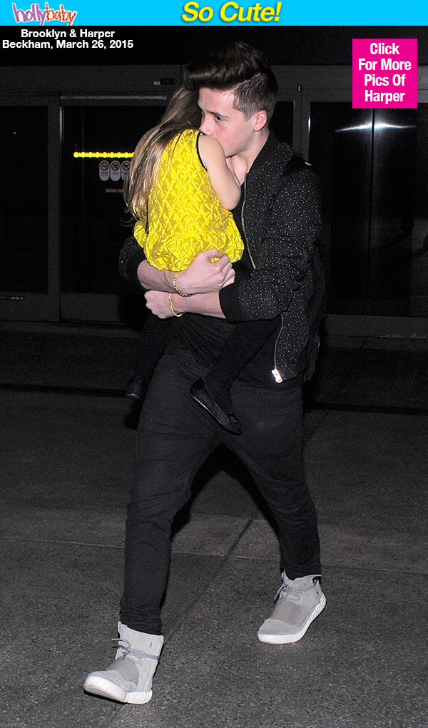 Brooklyn Beckham Carrying Harper Beckham