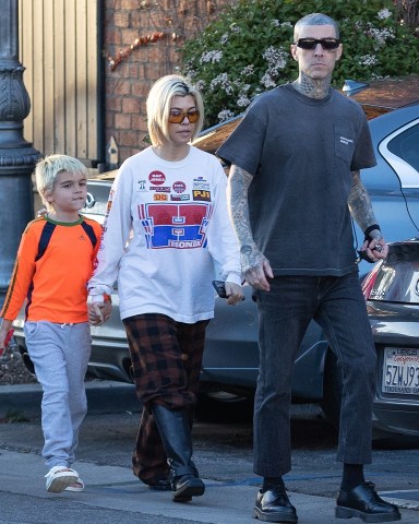 Calabasas, CA  - *EXCLUSIVE*  - Reality star Kourtney Kardashian sports a laidback look while out for an early dinner with her son Reign and husband Travis Barker at his restaurant Crossroads Kitchen. The vegan restaurant located in Calabasas has been a hit among the city's foodies, and its plant-based cuisine is well-known in the vegan community. The couple was seen holding hands as they arrived at the restaurant, and their casual outfits perfectly complemented each other.Pictured: Kourtney Kardashian, Travis BarkerBACKGRID USA 2 APRIL 2023 BYLINE MUST READ: LAGOSSIPTV / BACKGRIDUSA: +1 310 798 9111 / usasales@backgrid.comUK: +44 208 344 2007 / uksales@backgrid.com*UK Clients - Pictures Containing ChildrenPlease Pixelate Face Prior To Publication*