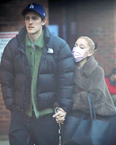 EXCLUSIVE: Ariana Grande and her husband Dalton Gomez indulge in Crepes from the famous La Creperie de Hampstead. The pint-sized pop star who is in the capital filming Wicked parts 1 & 2 looked adorable in an oversized coat, platform trainers, and a pink face mask that she removed to take some selfies near the popular stand that serves sweet and savoury french crêpes and has been a Hampstead favorite for many years. 23 Jan 2023 Pictured: Ariana Grande, Dalton Gomez. Photo credit: MEGA TheMegaAgency.com +1 888 505 6342 (Mega Agency TagID: MEGA939190_041.jpg) [Photo via Mega Agency]