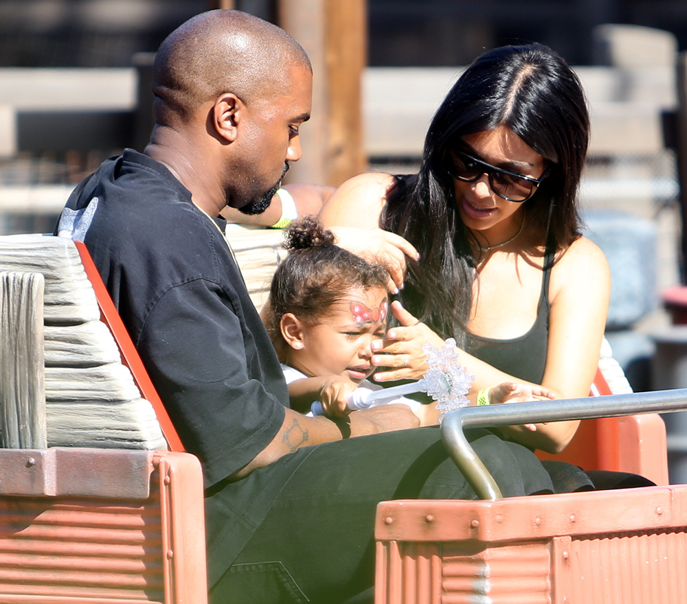 Kim Kardashian and Kanye West take yuoung daughter North on the Cars Ride as they are spotted celebrating her 2nd birthday at Disneyland in Anaheim, Ca