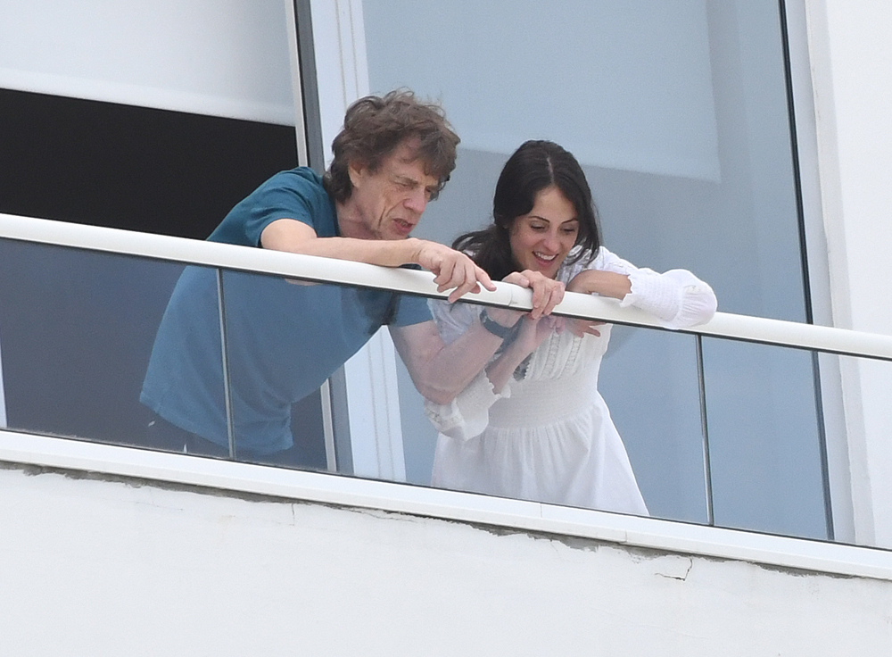 Rolling Stones frontman Mick Jagger and girlfriend Melanie Hamrick enjoy the view from their Miami Beach hotel balcony