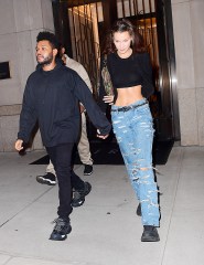 Bella Hadid and The Weeknd were spotted leaving her Manhattan NYC apartment on Friday night. The couple headed to dinner after reuniting following a busy Fashion Month for the Runway model. She flaunted her to-die-for abs in a crop top as they walked to their SUV. They were all smiles but they seemed to be playing coy about a large Diamond ring on Bella's hand. She hid one of her hands behind her back, while concealing an ENORMOUS diamond on the hand she had intertwined in the singer's. He covered the ring with 2 hands as they got into the car, just giving a quick glance at it.

Pictured: 
Ref: SPL5028849 280918 NON-EXCLUSIVE
Picture by: 247PAPS.TV / SplashNews.com

Splash News and Pictures
Los Angeles: 310-821-2666
New York: 212-619-2666
London: 0207 644 7656
Milan: +39 02 4399 8577
Sydney: +61 02 9240 7700
photodesk@splashnews.com

World Rights, No Portugal Rights