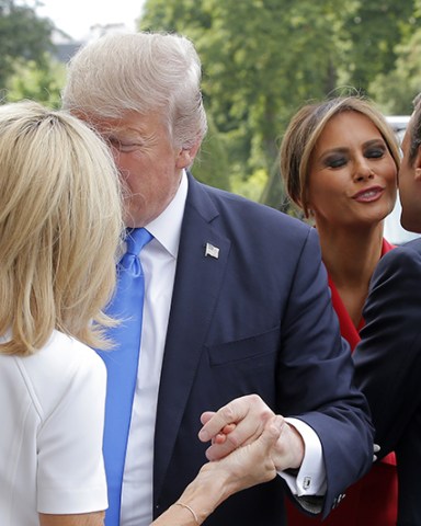 MAXPPP OUT
Mandatory Credit: Photo by MICHEL EULER/POOL/EPA/REX/Shutterstock (8960077h)
Emmanuel Macron, Melania Trump, Brigitte Macron and Donald J. Trump
Donald J. Trump's visit to Paris, France - 13 Jul 2017
French President Emmanuel Macron (R) welcomes First Lady Melania Trump (2-R) while his wife Brigitte (L) welcomes US President Donald J. Trump at Les Invalides museum in Paris, France, 13 July 2017. President Trump and French President Macron planned to meet 13 July in Paris to focus on issues where they can take US-French relations forward, with major security and defense topics among them.