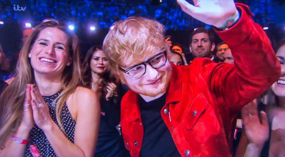 Video grab of Ed Sheeran and his girlfriend Cherry Seaborn at the Brit Awards on Feb 21st.

Pop star Ed Sheeran has revealed that his fiancee MADE an engagement ring for him, after responding to rumours that he secretly tied the knot.

The Shape of You singer, who was spotted wearing a silver band on his wedding finger at a gig earlier this week, said his childhood sweetheart, Cherry Seaborn, made the ring for him out of silver plate.

The 27-year-old, whose interview on the red carpet at the BRIT Awards was shown on ITV's Lorraine this morning, said: "It's the same commitment either way, so Cherry made it for me out of silver plate and I really like it. I haven't told anyone else about it yet."

* No UK Papers Or Web * Magazines Only / Worldwide Rights

Pictured: Cherry Seaborn,Ed Sheeran
Ref: SPL4188722 240218 NON-EXCLUSIVE
Picture by: Flynet - SplashNews / SplashNews.com

Splash News and Pictures
USA: +1 310-525-5808
London: +44 (0)20 8126 1009
Berlin: +49 175 3764 166
photodesk@splashnews.com

World Rights