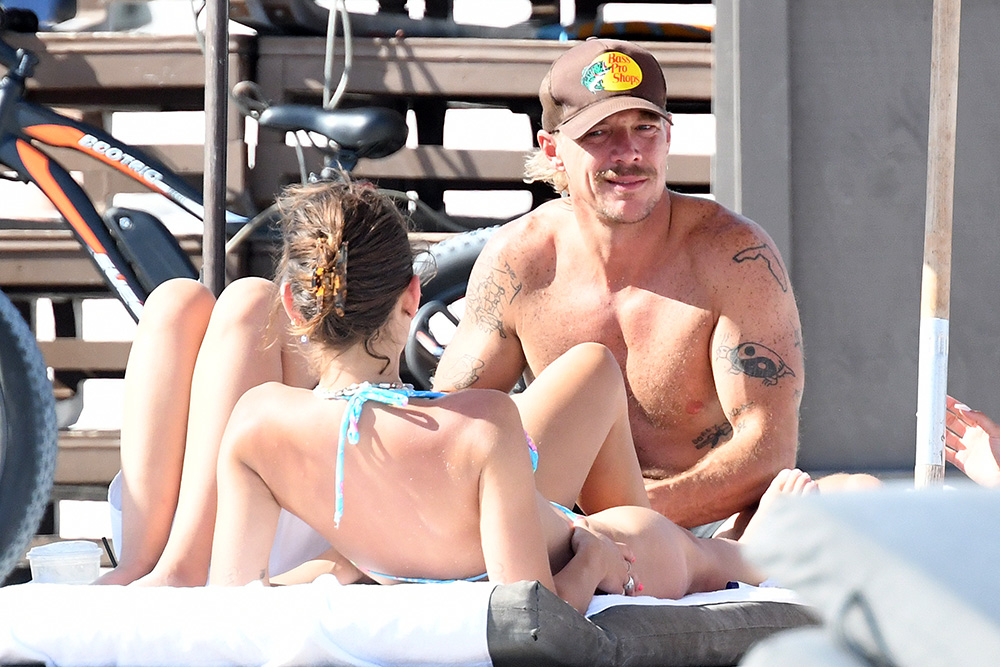 EXCLUSIVE: DJ Diplo looks happy as he is surrounded by bikini-clad women on the beach in Miami