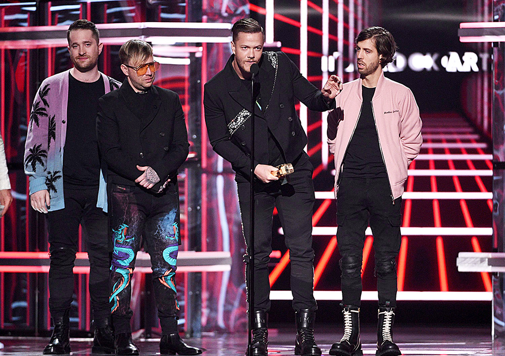 Daniel Platzman, Ben McKee, Dan Reynold, Wayne Sermon. Dan Reynolds, second right, and Daniel Platzman, from left, Ben McKee, and Wayne Sermon, of Imagine Dragons, accept the award for top rock artist at the Billboard Music Awards, at the MGM Grand Garden Arena in Las Vegas
2019 Billboard Music Awards - Show, Las Vegas, USA - 01 May 2019