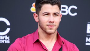 Nick Jonas wearing one suspender strap at the 2018 Billboard Music Awards