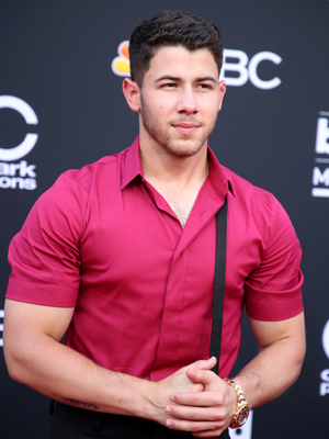 Nick Jonas wearing one suspender strap at the 2018 Billboard Music Awards