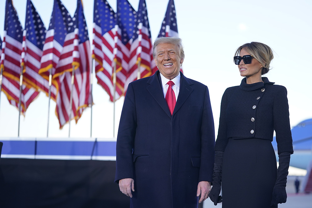 President Donald Trump and first lady Melania Trump greet the crowd before boarding Air Force One at Andrews Air Force Base, Md., Wednesday, Jan. 20, 2021.(AP Photo/Manuel Balce Ceneta)