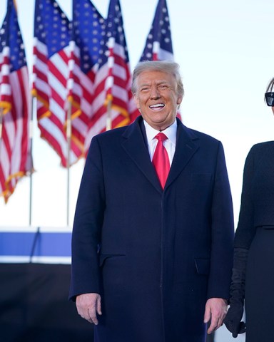 President Donald Trump and first lady Melania Trump greet the crowd before boarding Air Force One at Andrews Air Force Base, Md., Wednesday, Jan. 20, 2021.(AP Photo/Manuel Balce Ceneta)