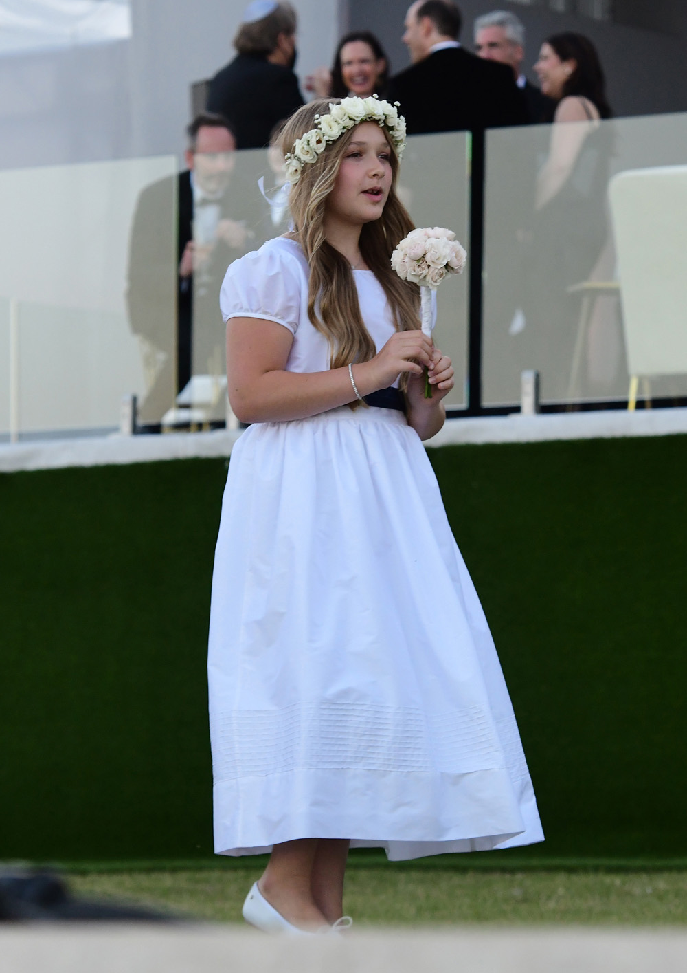 Harper Beckham is seen in her flower girl dress for her brother Brooklyn Beckham and Nicola Peltz wedding in Palm Beach