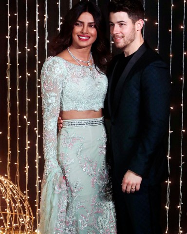 Bollywood actress Priyanka Chopra and musician Nick Jonas pose for photographs at their wedding reception in Mumbai, India
Chopra Jonas Wedding, Mumbai, India - 20 Dec 2018