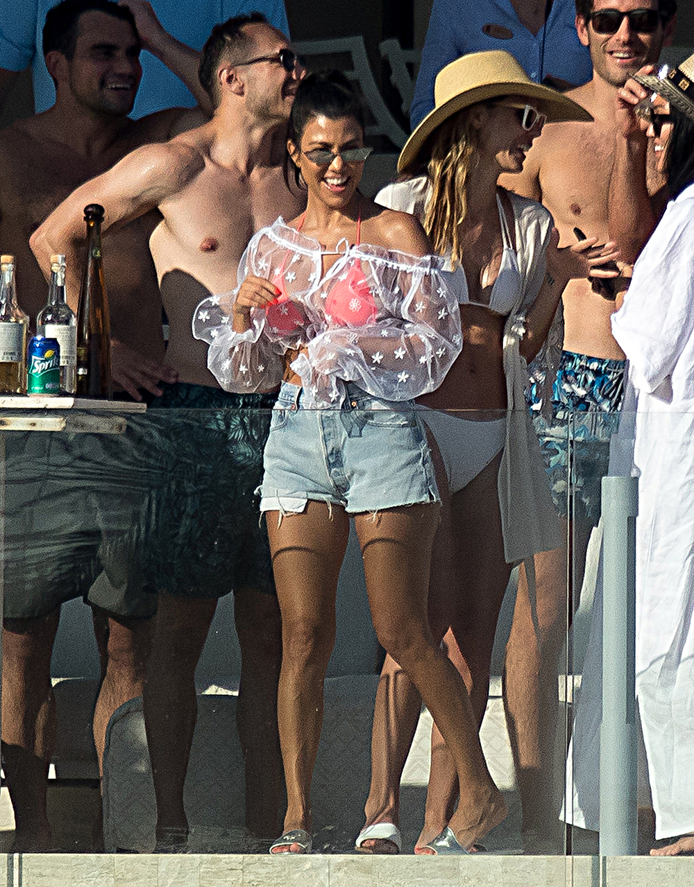 Kourtney Kardashian has fun at a pool bar in Mexico. Kourtney was laughing and joking with a group of people at a private members only beach club.