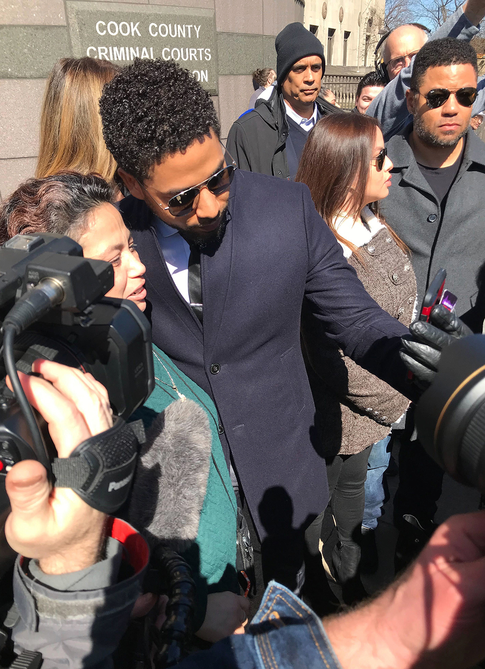 Actor Jussie Smollett poses for a selfie outside the Leighton Criminal Court Building after a hearing Tuesday, March 26, 2019, in Chicago. Smollett attorneys Tina Glandian and Patricia Brown Holmes said in a statement Tuesday that Smollett's record "has been wiped clean." Smollett was indicted on 16 felony counts related to making a false report that he was attacked by two men who shouted racial and homophobic slurs. (AP Photo/Amanda Seitz)