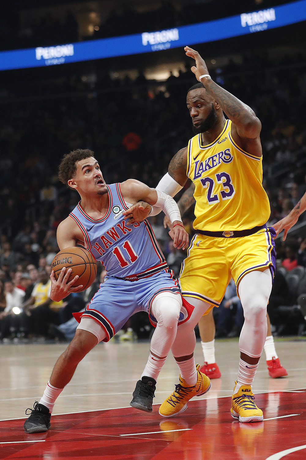 Atlanta Hawks guard Trae Young (11) drives against Los Angeles Lakers forward LeBron James (23) during the first half of an NBA basketball game Tuesday, Feb. 12, 2019, in Atlanta. (AP Photo/John Bazemore)