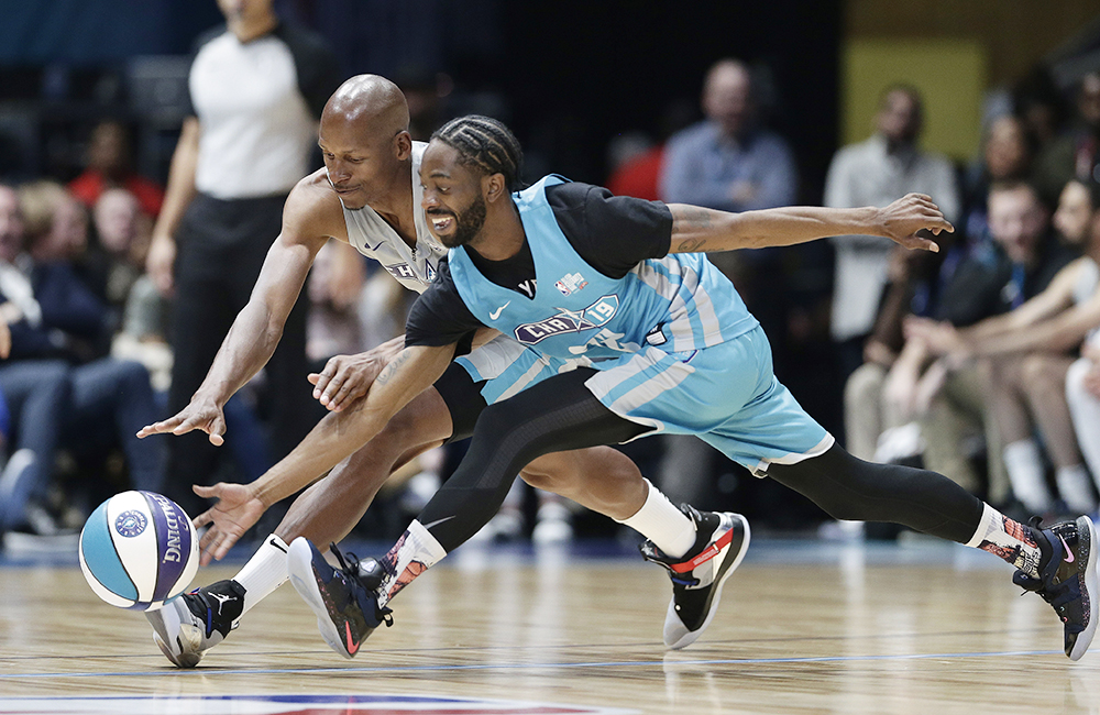 Home team's Famous Los, right, and Away team's Ray Allen chase the ball during the first half of an NBA All-Star Celebrity basketball game in Charlotte, N.C., Friday, Feb. 15, 2019. (AP Photo/Gerry Broome)