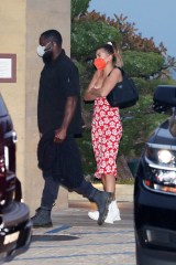 Hailey Bieber wears a red floral dress as she dines at Nobu Malibu in Malibu. 06 May 2021 Pictured: Hailey Bieber. Photo credit: Photographer Group/MEGA TheMegaAgency.com +1 888 505 6342 (Mega Agency TagID: MEGA752155_003.jpg) [Photo via Mega Agency]