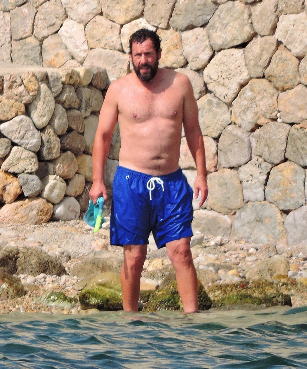 *EXCLUSIVE*  Adam Sandler takes a break from his filming duties to relax out on the beach in Palma De Mallorca