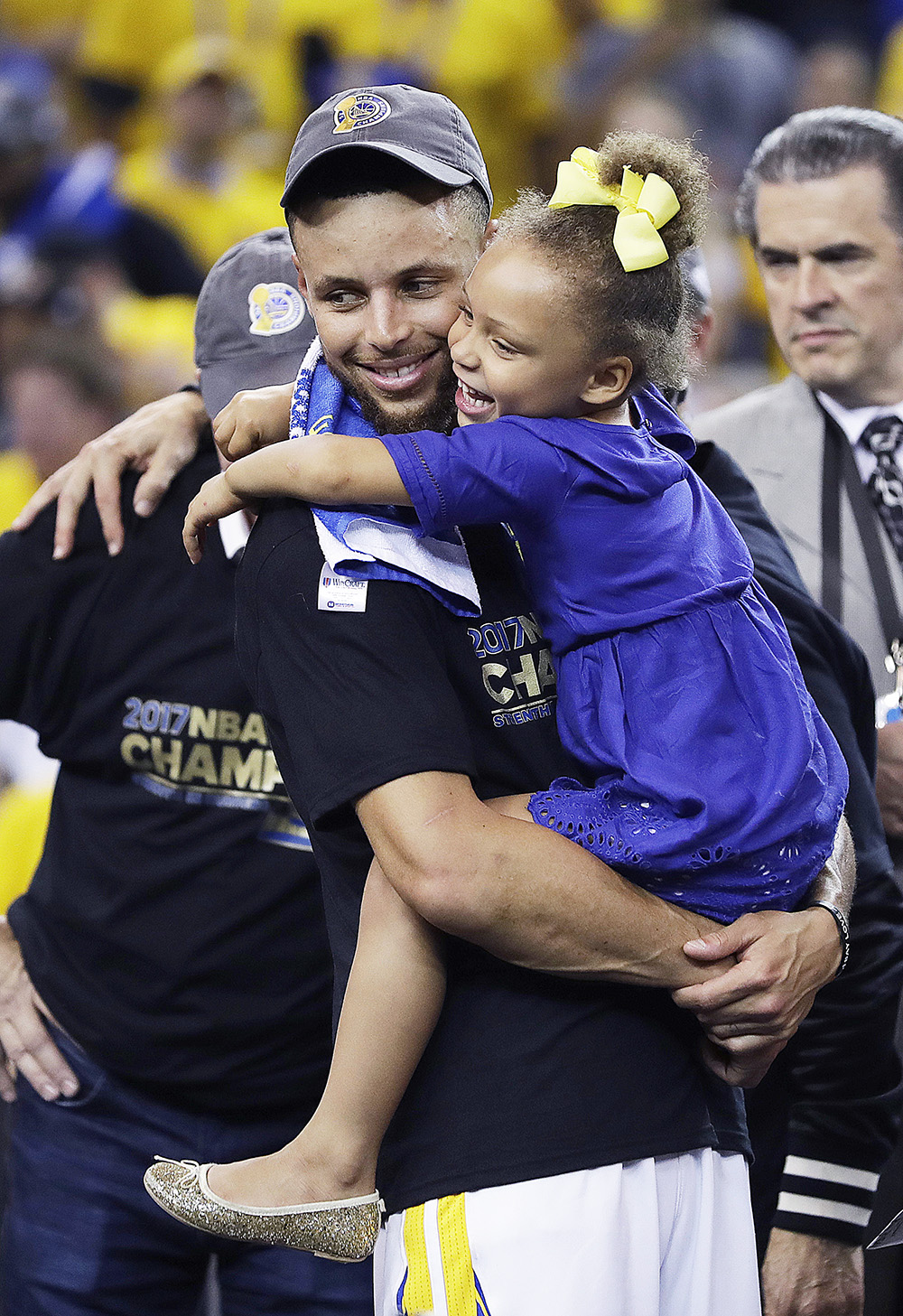 Golden State Warriors guard Stephen Curry hugs his daughter Riley after Game 5 of basketball's NBA Finals between the Warriors and the Cleveland Cavaliers in Oakland, Calif., Monday, June 12, 2017. The Warriors won 129-120 to win the NBA championship. (AP Photo/Marcio Jose Sanchez)