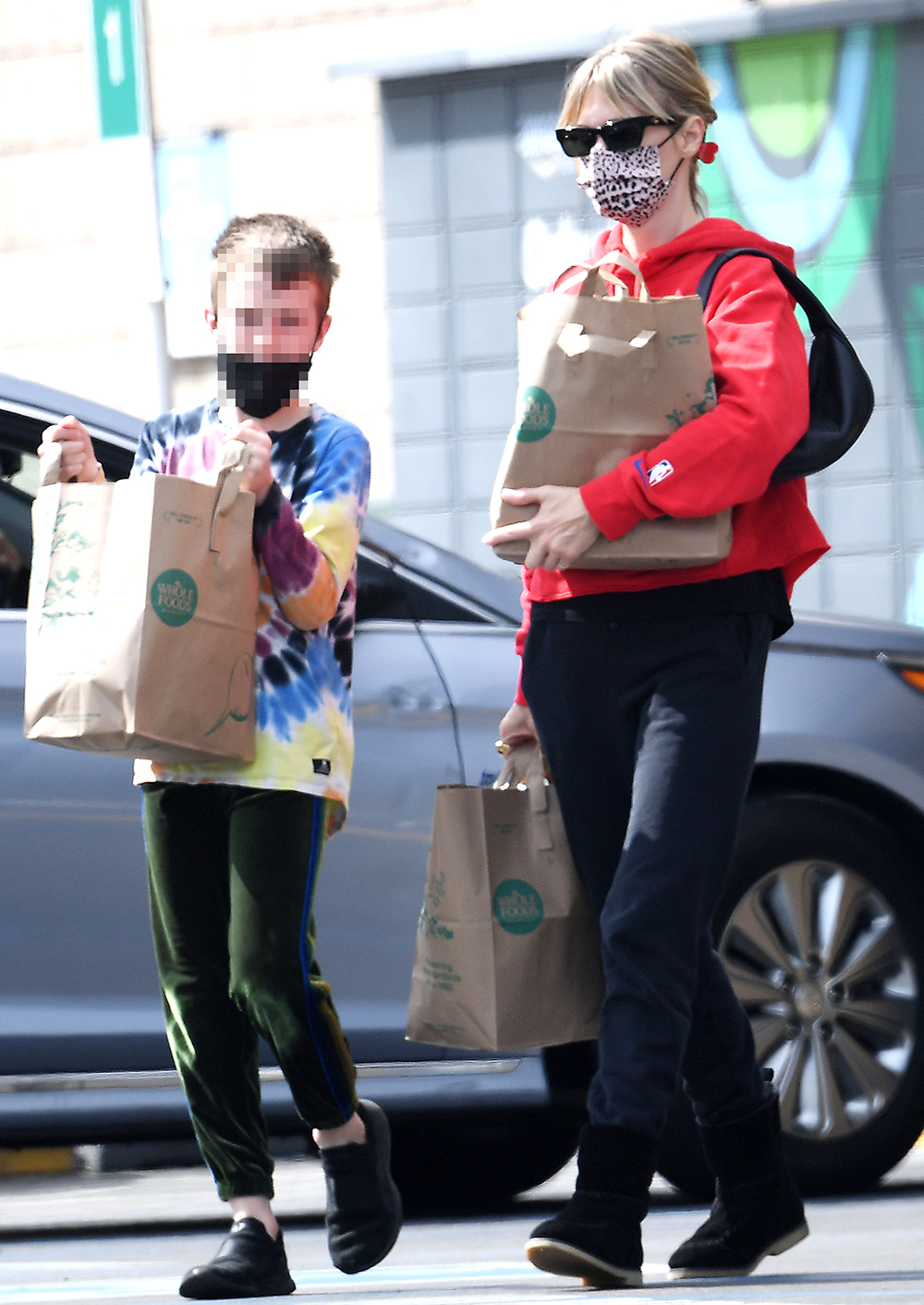 EXCLUSIVE: January Jones goes grocery shopping with Xander at Whole Foods grocery store in Los Angeles on Sunday. January was proudly wearing her Los Angeles Clippers sweatshirt one day after they beat their crosstown rival the Lakers. Xander helped his mother carry the bags of groceries on the way from the popular natural food store. 06 Mar 2022 Pictured: January Jones goes shopping for groceries with Xander. Photo credit: GP/MEGA TheMegaAgency.com +1 888 505 6342 (Mega Agency TagID: MEGA835247_004.jpg) [Photo via Mega Agency]