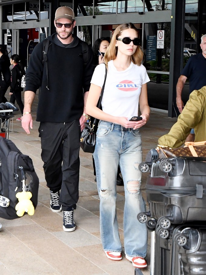 Liam Hemsworth & Gabriella Brooks At The Airport