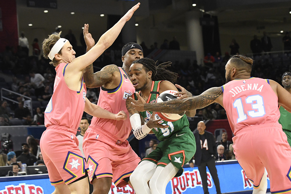 Team Stephen A's Quavo, center, is defended by Team Wilbon's Jidenna, right, and Alex Moffat, left, during the first half of the NBA Celebrity All-Star basketball game Friday, Feb. 14, 2020, in Chicago. (AP Photo/David Banks)