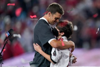 Tampa Bay Buccaneers quarterback Tom Brady embraces his son after defeating the Kansas City Chiefs in the NFL Super Bowl 55 football game Sunday, Feb. 7, 2021, in Tampa, Fla. The Buccaneers defeated the Chiefs 31-9 to win the Super Bowl. (AP Photo/Mark Humphrey)