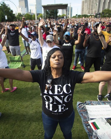 Woman prays during a OneRace March on Atlanta prayer service and march in response to recent racially violence, in Atlanta
Juneteenth , Atlanta, United States - 19 Jun 2020