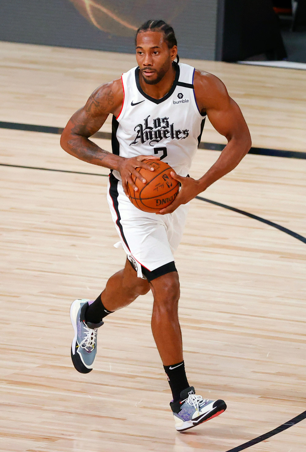 Los Angeles Clippers' Kawhi Leonard dribbles down court against the Phoenix Suns during the first half of an NBA basketball game against the Phoenix Suns' Tuesday, Aug. 4, 2020, in Lake Buena Vista, Fla. (Kevin C. Cox/Pool Photo via AP)