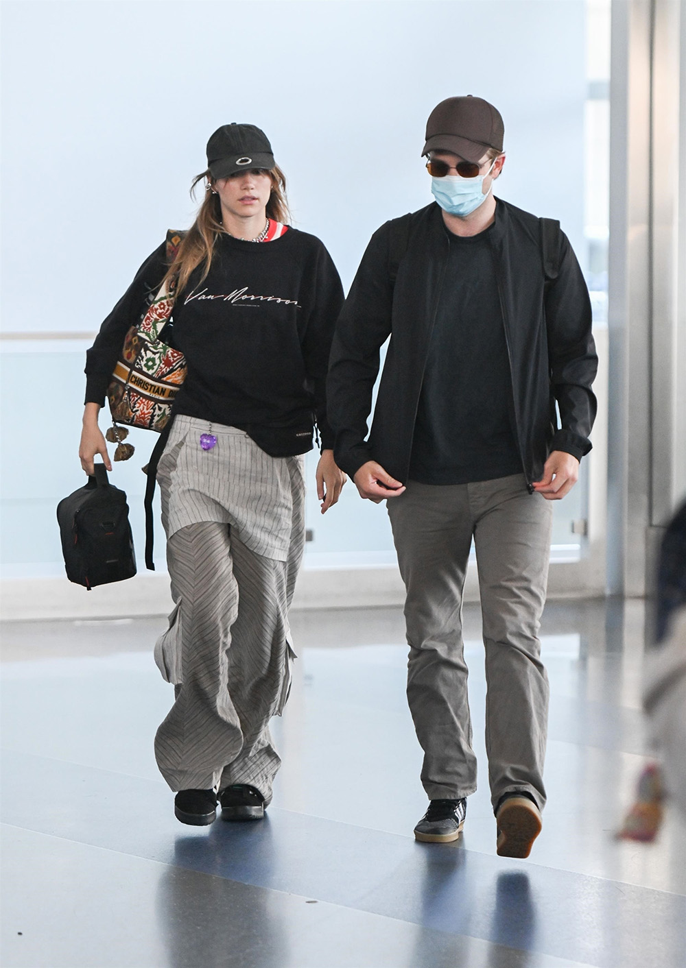 *EXCLUSIVE* Robert Pattinson and Suki Waterhouse touch down at JFK airport wearing matching outfits