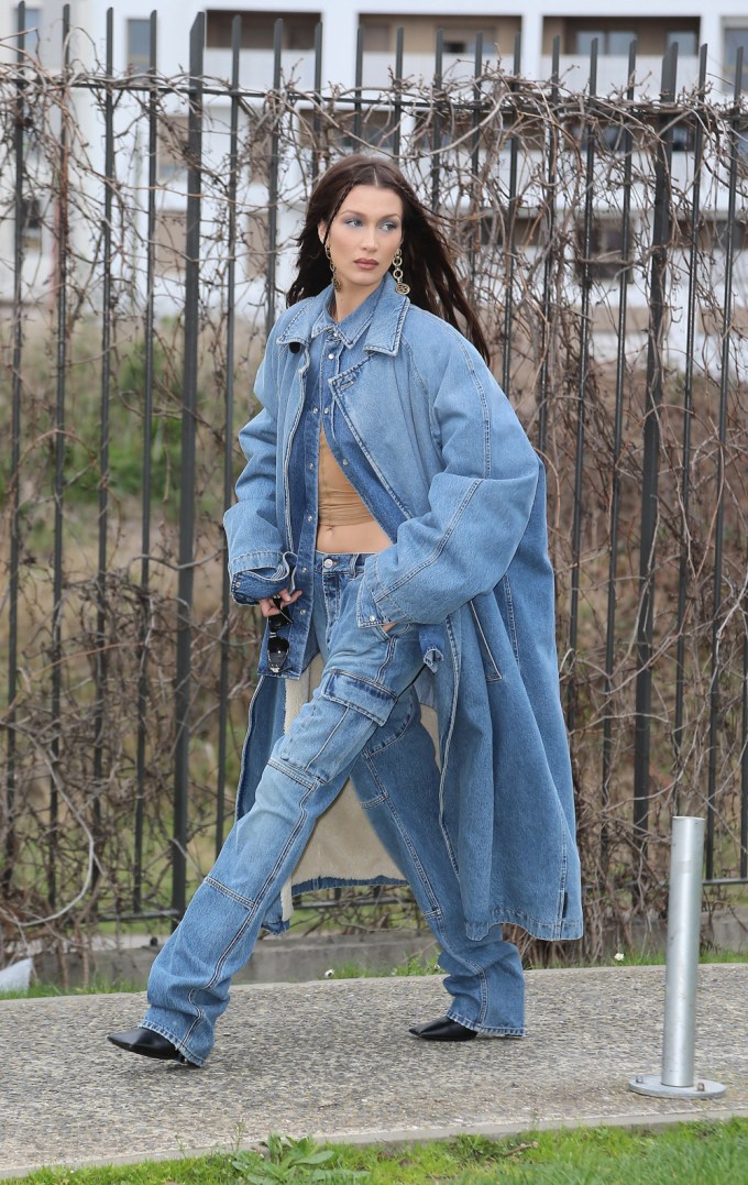 Bella Hadid wears Balenciaga jeans and matching denim coat.