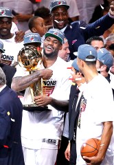 Miami Heat LeBron James holds the the Larry O'Brien NBA Championship Trophy after Game 5 of the NBA finals basketball series against the Oklahoma City Thunder, Friday, June 22, 2012, in Miami. The Heat won 121-106 to become the 2012 NBA Champions.
(AP Photo/Tom DiPace)