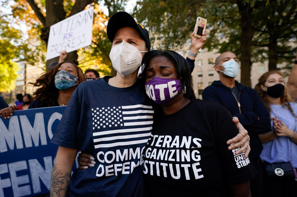 People gathered in Black Lives Matter Plaza, react to the presidential race being called in Joe Biden's favor, Saturday, Nov. 7, 2020, in Washington. (AP Photo/Alex Brandon)