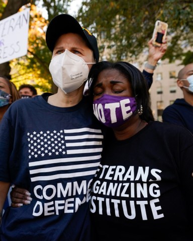 People gathered in Black Lives Matter Plaza, react to the presidential race being called in Joe Biden's favor, Saturday, Nov. 7, 2020, in Washington. (AP Photo/Alex Brandon)