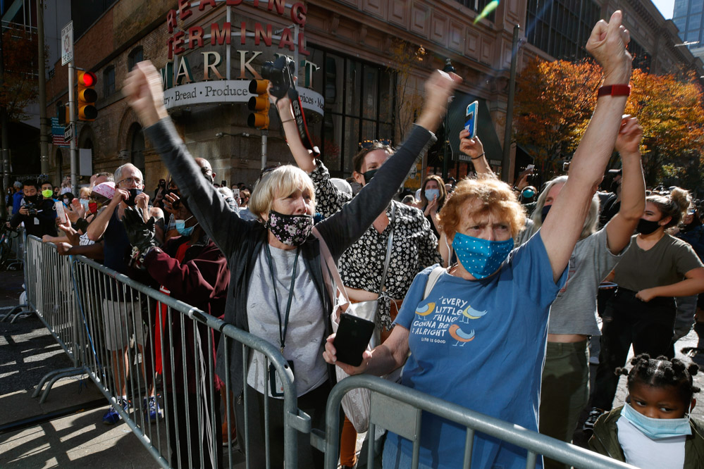 People celebrate outside the Pennsylvania Convention Center, Saturday, Nov. 7, 2020, in Philadelphia, after Democrat Joe Biden defeated President Donald Trump to become 46th president of the United States. (AP Photo/Rebecca Blackwell)