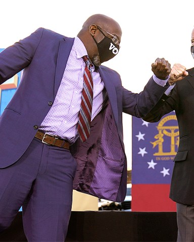 President-elect Joe Biden elbow bumps Senate candidate Raphael Warnock in Atlanta, Monday, Jan. 4, 2021, during a campaign rally for Warnock and Jon Ossoff. (AP Photo/Carolyn Kaster)