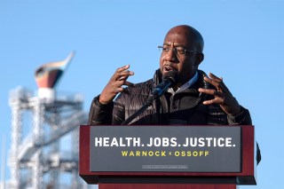 Democratic Georgia Senate challenger the Rev. Raphael Warnock addresses supporters during a rally with Jon Ossoff in Atlanta on the first day of early voting for the senate runoff Monday, Dec. 14, 2020. (AP Photo/Ben Gray)