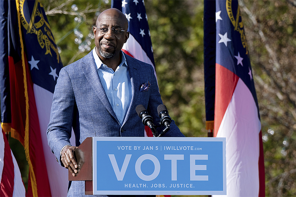 FILE - In this Dec. 21, 2020, file photo Democratic U.S. Senate challenger the Rev. Raphael Warnock speaks during a rally in Columbus, Ga. with Vice President-elect Kamala Harris and fellow Democratic U.S. Senate challenger Jon Ossoff. (AP Photo/Ben Gray, File)