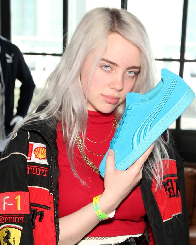 Billie Eilish styles her white locks in loose waves