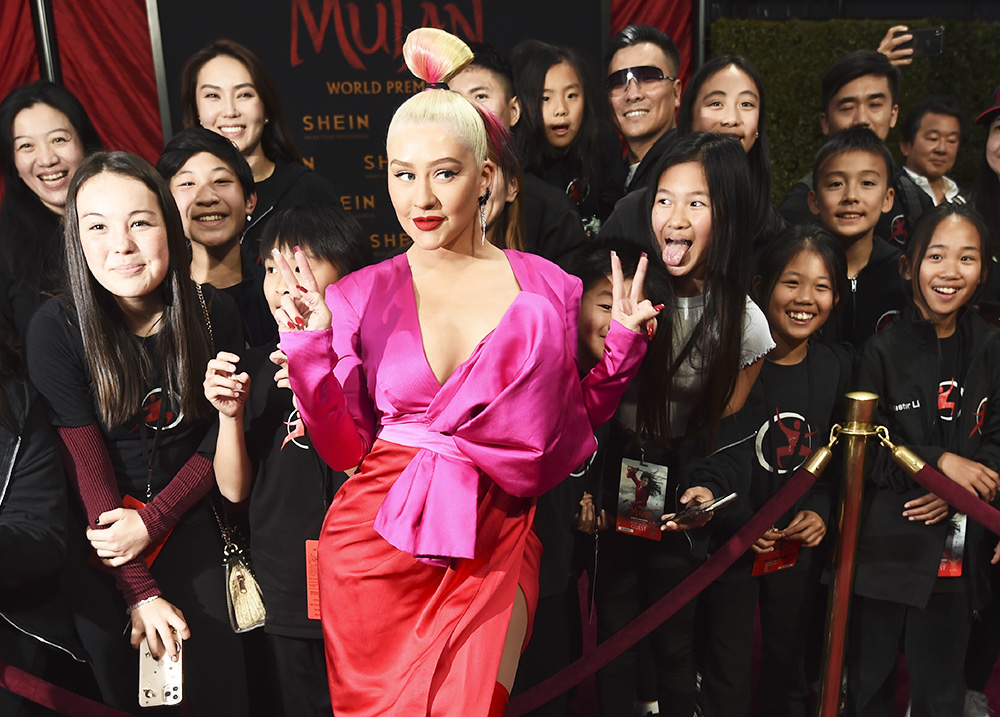 Singer Christina Aguilera poses with fans at the premiere of the film "Mulan" at the El Capitan Theatre, Monday, March 9, 2020, in Los Angeles. (AP Photo/Chris Pizzello)