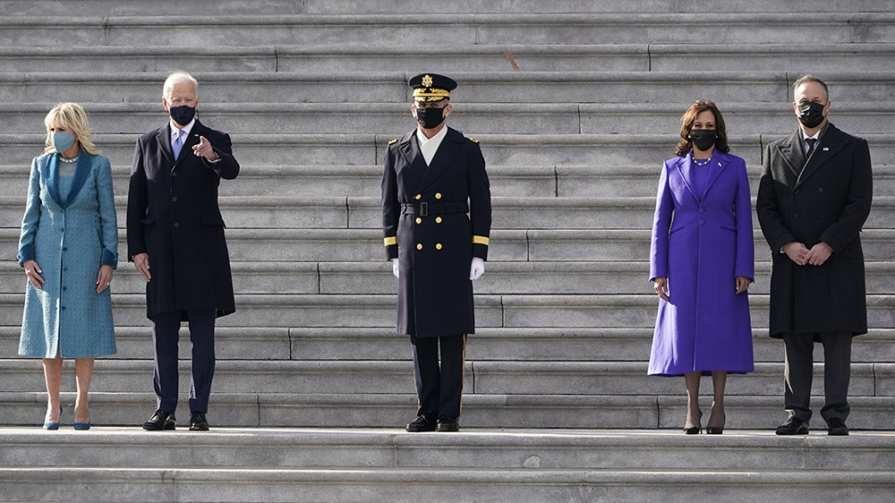 President Joe Biden his wife Jill Biden and Vice President Kamala Harris her husband Doug Emhoff watch a military pass in review ceremony on the East Front of the Capitol at the conclusion of the inauguration ceremonies, in Washington, Wednesday, Jan. 20, 2021. (AP Photo/J. Scott Applewhite)