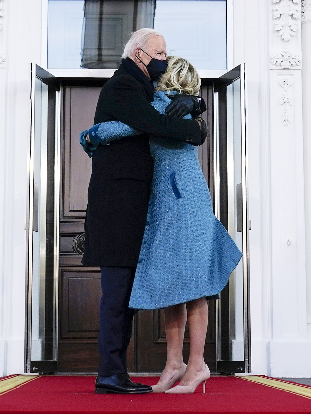 President Joe Biden hugs first lady Jill Biden as they arrive at the North Portico of the White House, Wednesday, Jan. 20, 2021, in Washington. (AP Photo/Evan Vucci)