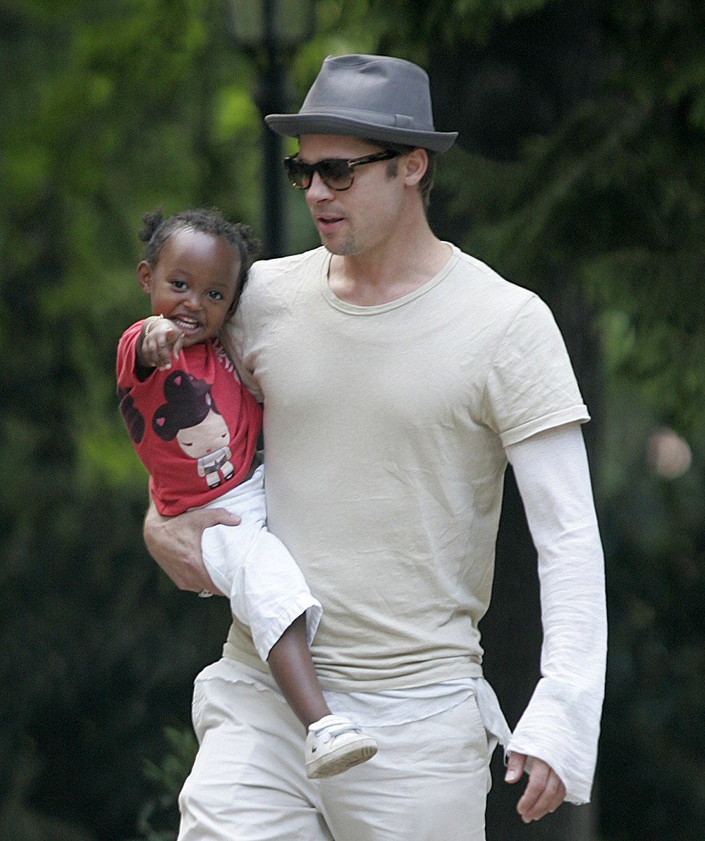 Actor Brad Pitt carries Zahara into a pre-school in Prague