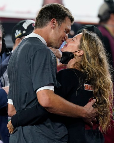 Tampa Bay Buccaneers quarterback Tom Brady kisses wife Gisele Bundchen after defeating the Kansas City Chiefs in the NFL Super Bowl 55 football game Sunday, Feb. 7, 2021, in Tampa, Fla. The Buccaneers defeated the Chiefs 31-9 to win the Super Bowl. (AP Photo/Mark Humphrey)